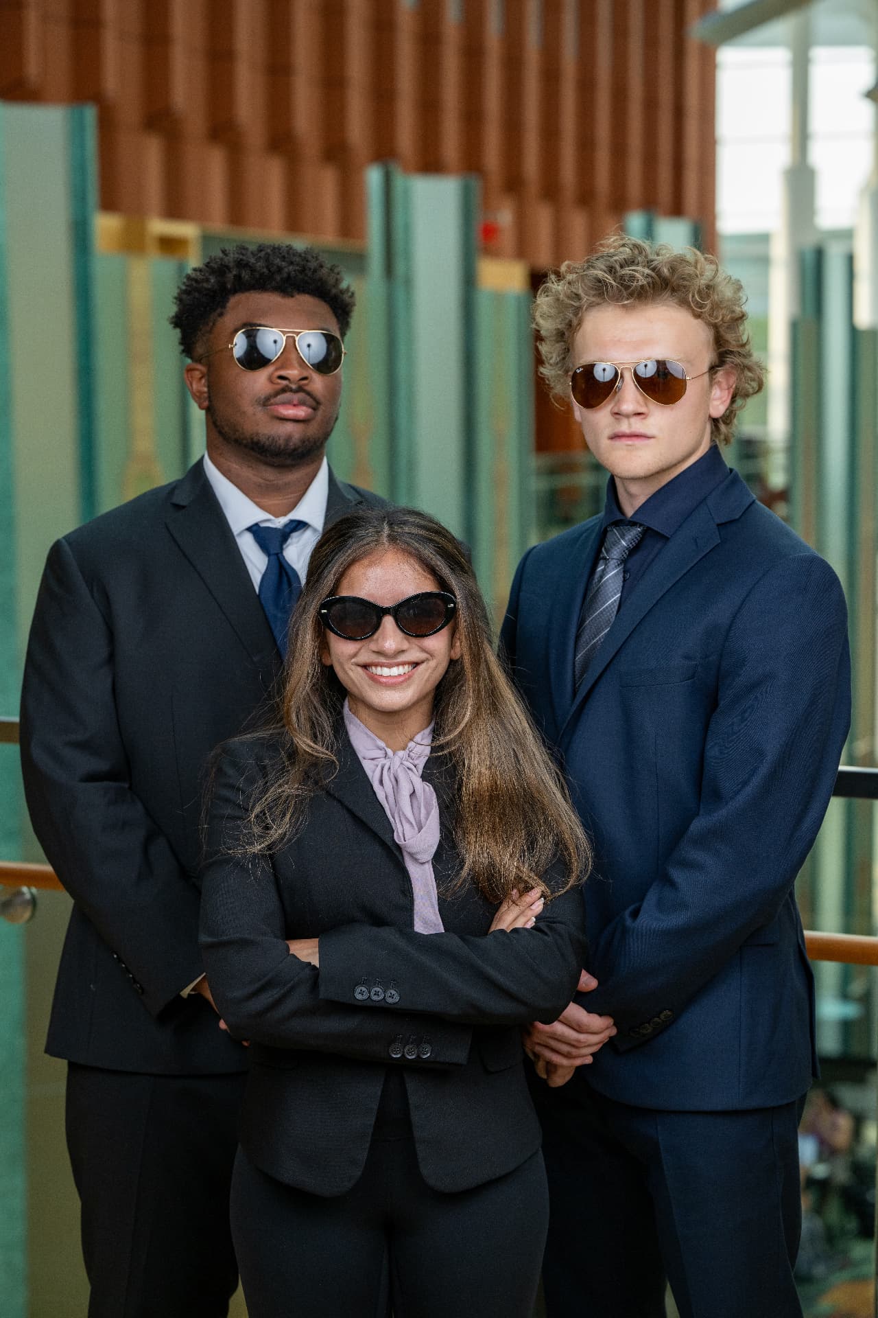 Grace with two fellow mentors in business attire at Ross
